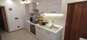 a kitchen with a sink and a counter top at B&B Ai Carpini in San Pietro di Cadore