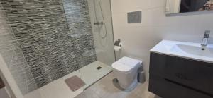 a bathroom with a shower and a toilet and a sink at Casa Vitamin Sea in La Horadada