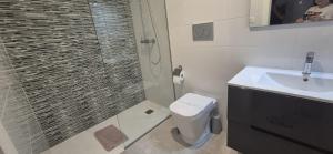 a bathroom with a shower and a toilet and a sink at Casa Vitamin Sea in La Horadada