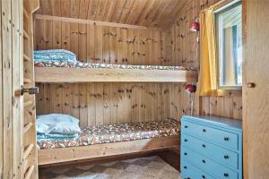 a wooden cabin with two bunk beds and a window at LN76102-Hjorring-Kystvejen-116 in Hjørring
