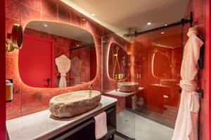 a bathroom with two sinks and a large mirror at Nhow Lima in Lima