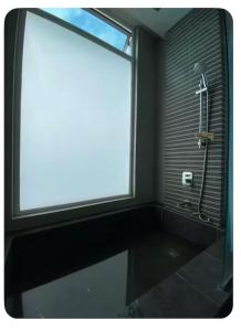 a bathroom with a shower and a large window at Setapak Central Mall Bathtub & Netflix in Kuala Lumpur