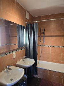 a bathroom with two sinks and a shower and a tub at Bright, Modernized Apartment at Belval University in Esch-sur-Alzette +9 photos