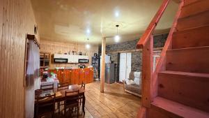 a kitchen and living room with a staircase in a house at Ela in Ushguli