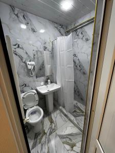 a bathroom with a toilet and a sink at Station House EVN in Yerevan +17 photos