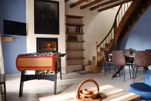 a living room with a table and a fireplace at Gîte en Sarthe avec sauna et jacuzzi in Saint-Georges-du-Rosay