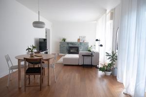 a living room with a table and a fireplace at Cjase mê in Tarcento