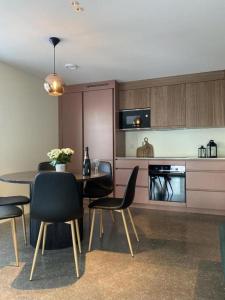 a kitchen with a table and chairs and a kitchen with a counter at B2 Lakeside Suite Polku Hotel in Vihti