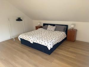 a bedroom with a bed and two night stands at Gorgeous cottage home in Novi Marof