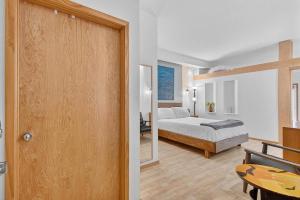 a bedroom with a bed and a room with a door at 302A Village View | European Village in Bon Terra