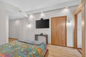 a bedroom with a bed and a flat screen tv at 302B Market View | European Village in Palm Coast