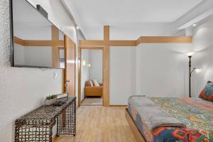 a bedroom with a bed and a large mirror at 302B Market View | European Village in Palm Coast +21 photos