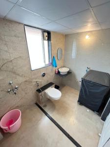 a bathroom with a toilet and a sink at Tej Villa, 3 Bhk villa at pushpam sanskruti,Karjat in Dhamni