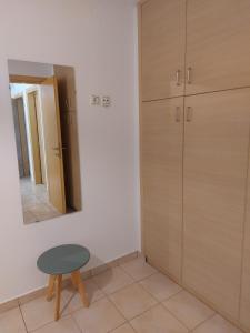 a dressing room with a stool and a mirror at Samos Cozy Apartment II in Samos