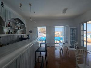 a bar in a restaurant with chairs and tables at Golden Sun in Ios Chora
