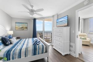 a bedroom with a bed and a ceiling fan at Oceanfront Beachside Condo - Pool, Beach, & Views in Chicken Island