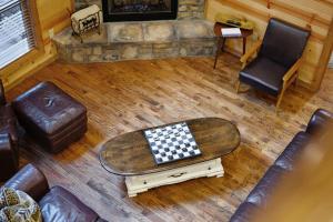 an overhead view of a living room with a chessboard on a table at Fireside in Broken Bow