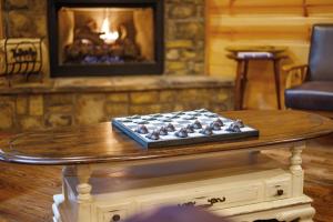 a table in a living room with a fireplace at Fireside in Broken Bow