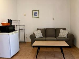 a living room with a couch and a coffee table at Sejong Guest house - 세종게스트하우스 in Trnava