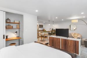 a bedroom with a bed and a living room at Sunnyside Studio on Green Lake in Seattle