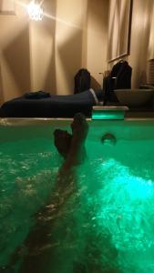 a person in a pool of water in a room at Appartement Loft Detente in Strasbourg