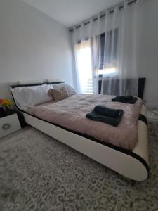 a bed with two pillows on it in a bedroom at Diana in Hemeius +4 photos
