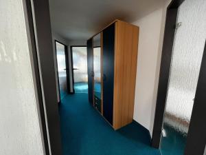 a hallway with a wooden door in a room at Wohnung in Waldnähe in Waltershausen +32 photos
