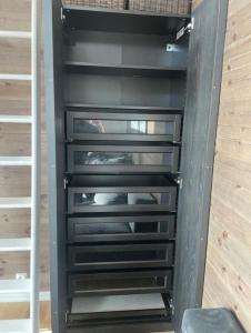 a closet with black drawers in a room at Mountain Cabin with Ski-in Access in Björnrike 
