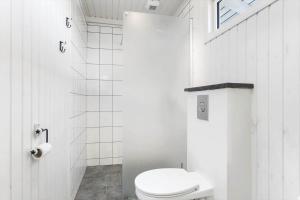 a white bathroom with a toilet and a window at LN866-Hjorring-Ostersovej-34 in Hjørring +15 photos