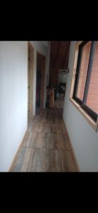 a hallway of a house with a wooden floor at Cabaña en el claro in Pucón +1 photo