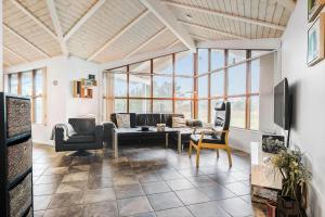 a living room with a couch and a table at LN1900-Hirtshals-Kragekaeret-11 in Hirtshals