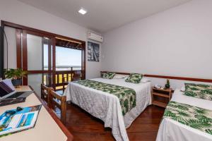 Giường trong phòng chung tại Praia Grande Hotel