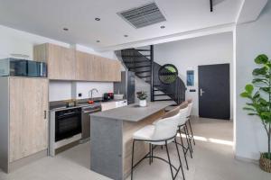 a kitchen with a spiral stair in the ceiling at Villa Trapezia Diamond in Kolymbia