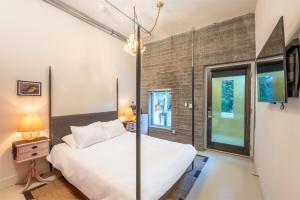 a bedroom with a bed and a large window at Hotel Narcissus in San Diego