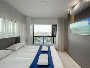 En eller flere senge i et værelse på Alto Luxo e uma Bela Vista no Edifício Vertigo + 18 billeder