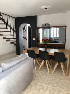 a living room with a couch and a table with chairs at Casa Nutt by the Sea in Torrox