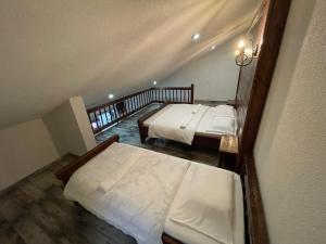 a room with two beds in a room at Hotel Hani in Peje
