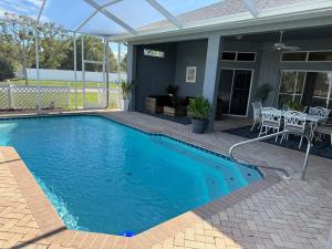 a swimming pool with blue water in front of a house at Beautiful vacation house on the hill in Spring Hill