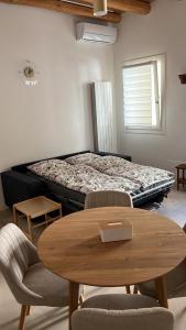 a bed in a room with a table and chairs at Mazzini Stay in Gorizia