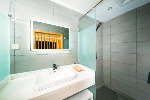 a bathroom with a sink and a mirror at Zhuzhi Light Luxury B&B in Lijiang +5 photos