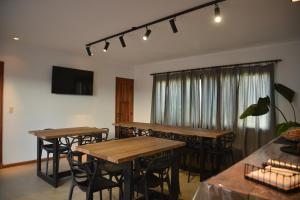 a group of tables and chairs in a room at Beach House AP in Miramar
