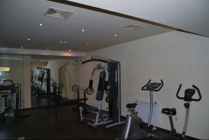 a gym with several exercise bikes and a mirror at Лари Б01 in Borovets