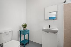 a bathroom with a toilet and a sink at 65 Condado by Otium in San Juan +65 photos