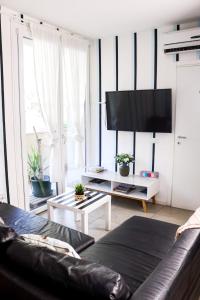 a living room with a couch and a flat screen tv at Celeste's House in Florence +31 photos