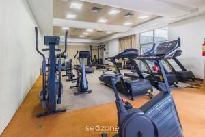 a gym with treadmills and elliptical machines at Estúdio Vista Mar em Recife BCI1603 in Recife
