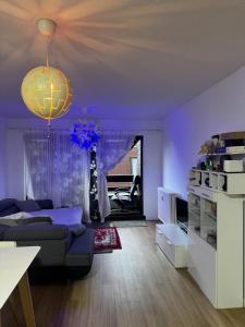 a purple living room with a couch and a chandelier at Luxurious apartment in Auderghem in Brussels