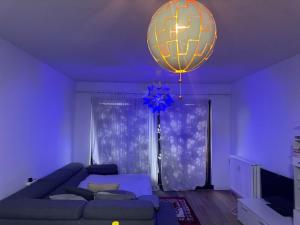 a living room with a couch and a chandelier at Luxurious apartment in Auderghem in Brussels +10 photos