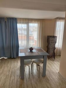 a dining room table and chairs in a room at Къща за гости DOSH in Sozopol