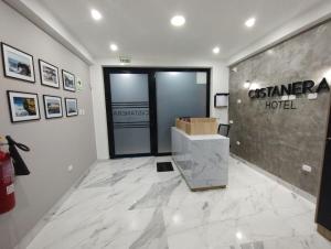 a lobby of a casenna hotel with a sign on the wall at Costanera Hotel in San Juan