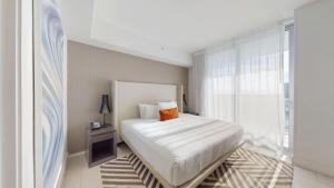 a white bedroom with a bed and a window at Hyde Beach House 3BR2BA in Hollywood